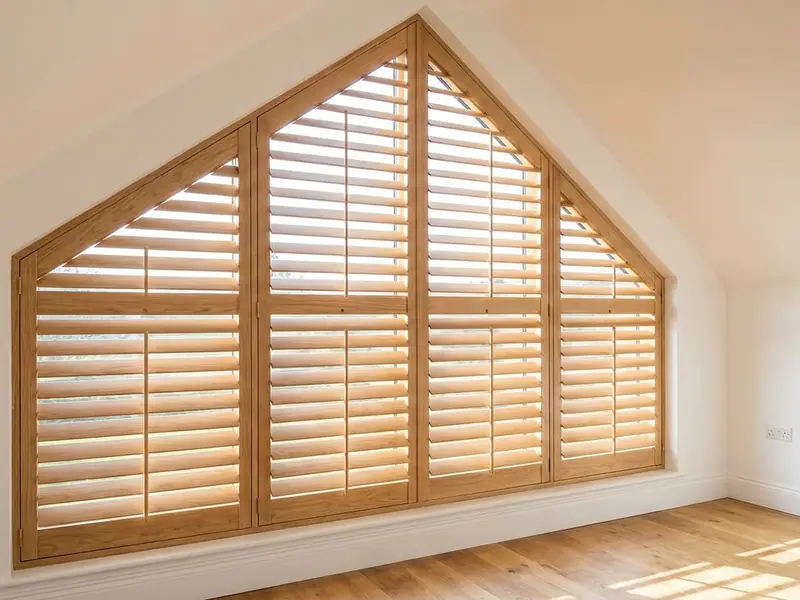 Shutters cut to a raked gable window