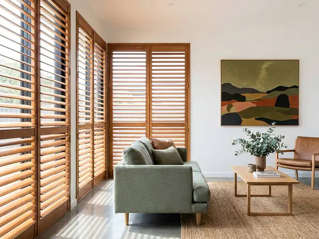 White timber plantation shutters in a coastal living room